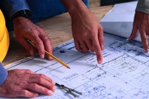 Facility managers reviewing blueprints